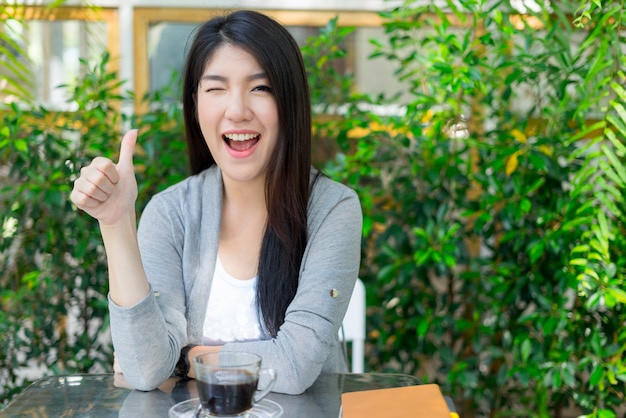 Happy girl look at camera laughing and smiling in cafe