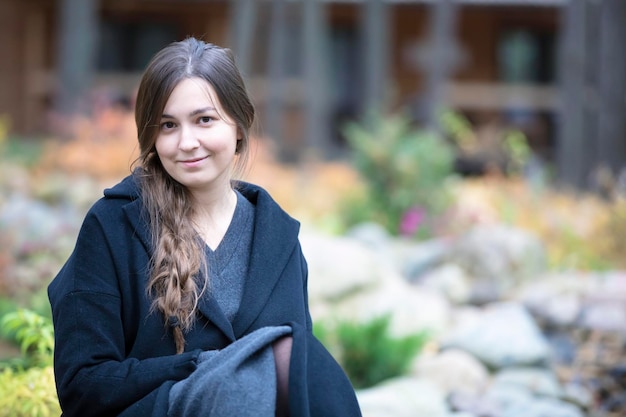 Happy girl in nature Portrait of an ordinary young woman outdoors