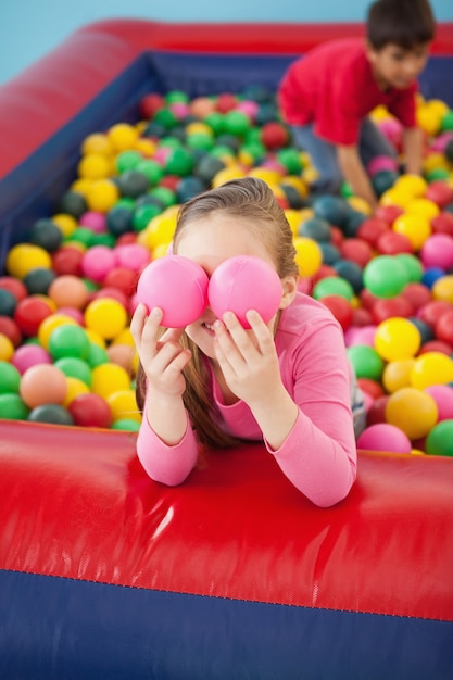 Happy girl playing in ball pool