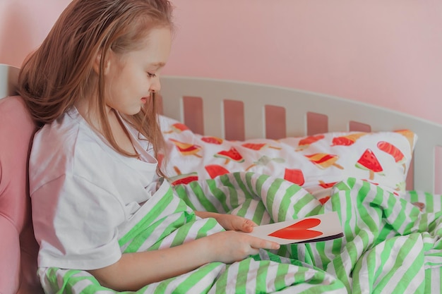 happy girl reading a greeting card for Valentine's day homemade