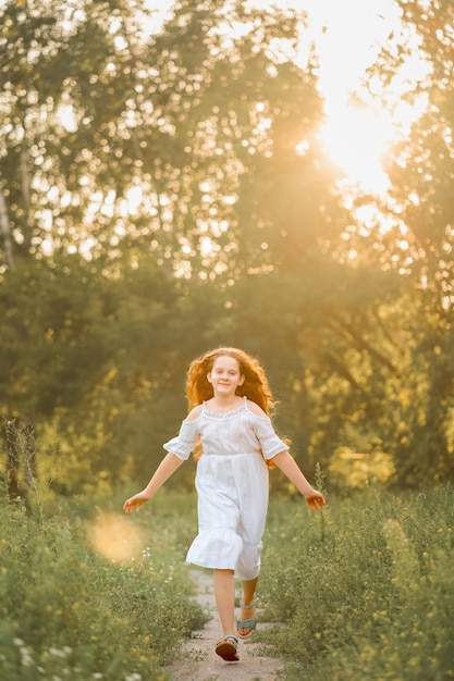 A happy girl runs along the park path