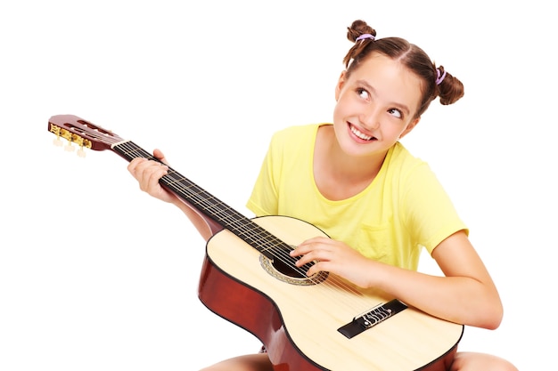 a happy girl sitting over white background with a guitar