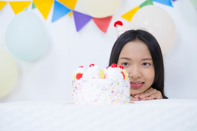 Happy girl with cake on birth day party.