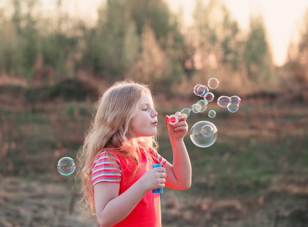 Happy girl with soap bubbles