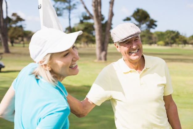 Happy golfer couple with white flag