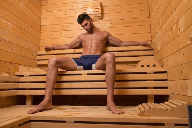 Happy Good Looking And Attractive Young Man With Muscular Body Relaxing In Sauna Hot