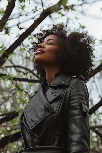 Happy good looking black woman wearing grey leather coat