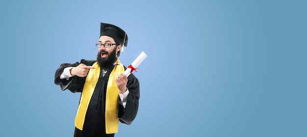 Happy graduate pointing at diploma