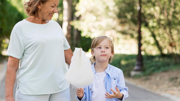 Happy grandma and kid with cotton candy