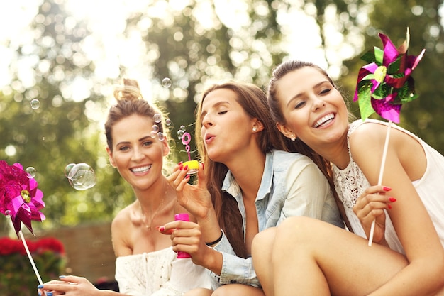 happy group of friends sitting outdoors