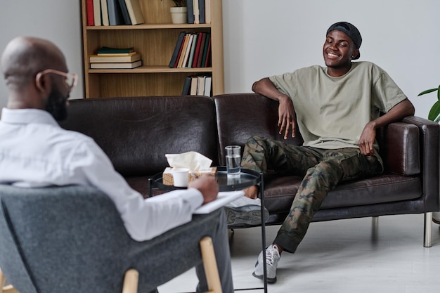 Happy guy visiting psychologist at office