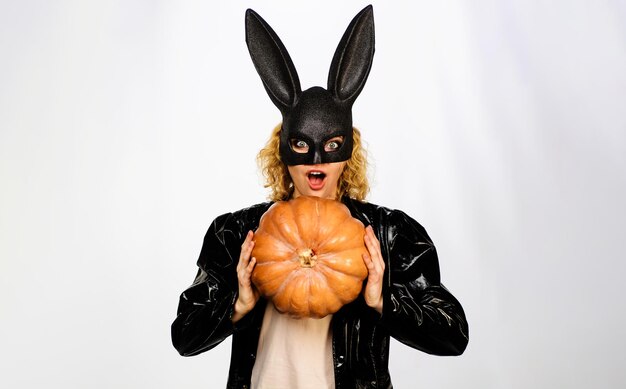 Photo happy halloween beautiful woman in halloween costume and bunny rabbit mask with pumpkin pretty