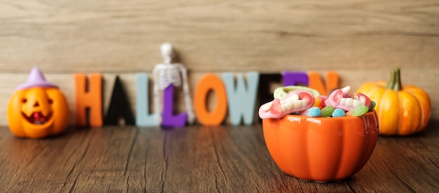 Happy Halloween day with ghost candies, pumpkin bowl, Jack O lantern and decorative (selective focus). Trick or Threat, Hello October, fall autumn, Festive, party and holiday concept