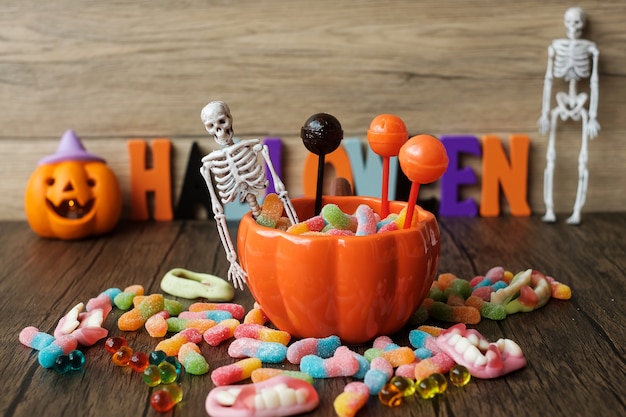 Happy Halloween day with ghost candies, pumpkin bowl, Jack O lantern and decorative (selective focus). Trick or Threat, Hello October, fall autumn, Festive, party and holiday concept