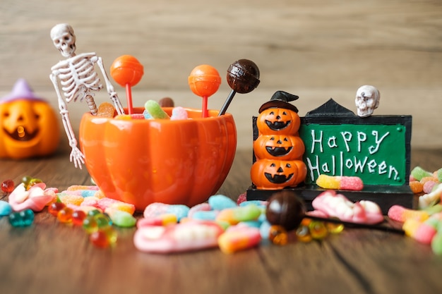 Happy Halloween day with ghost candies, pumpkin bowl, Jack O lantern and decorative (selective focus). Trick or Threat, Hello October, fall autumn, Festive, party and holiday concept