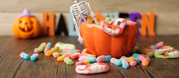 Happy Halloween day with ghost candies pumpkin bowl Jack O lantern and decorative selective focus Trick or Threat Hello October fall autumn Festive party and holiday concept