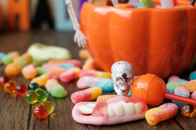 Happy Halloween day with ghost candies pumpkin bowl Jack O lantern and decorative selective focus Trick or Threat Hello October fall autumn Festive party and holiday concept