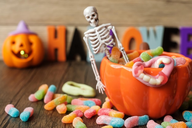 Happy Halloween day with ghost candies pumpkin bowl Jack O lantern and decorative selective focus Trick or Threat Hello October fall autumn Festive party and holiday concept