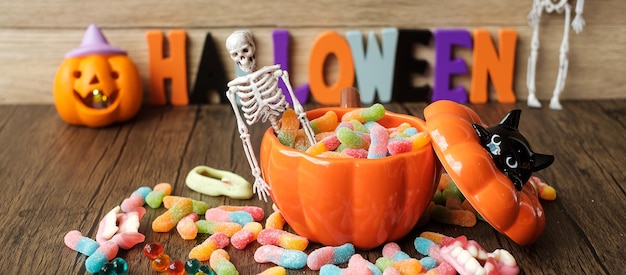 Happy Halloween day with ghost candies pumpkin bowl Jack O lantern and decorative selective focus Trick or Threat Hello October fall autumn Festive party and holiday concept