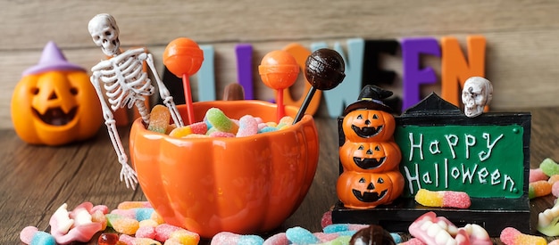 Happy Halloween day with ghost candies pumpkin bowl Jack O lantern and decorative selective focus Trick or Threat Hello October fall autumn Festive party and holiday concept