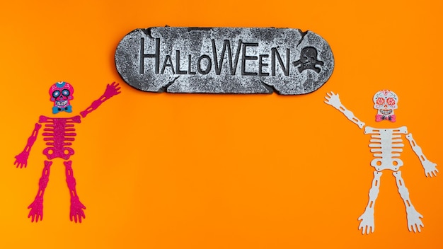 Happy Halloween holiday concept Orange Halloween background design decorations bats patterns on skeletons sign that says Halloween