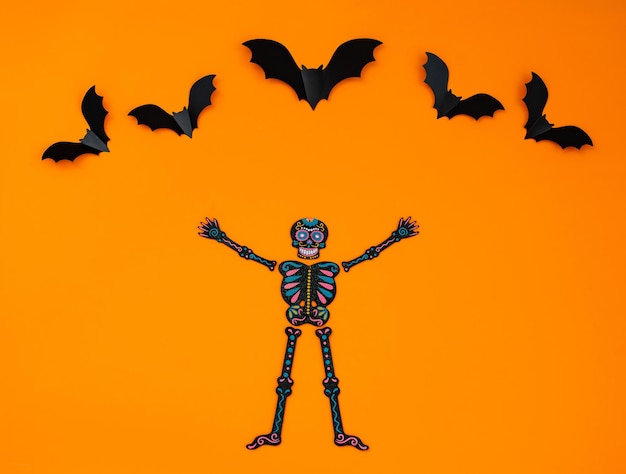 Happy Halloween holiday concept Orange Halloween background design decorations bats patterns on skeletons sign that says Halloween