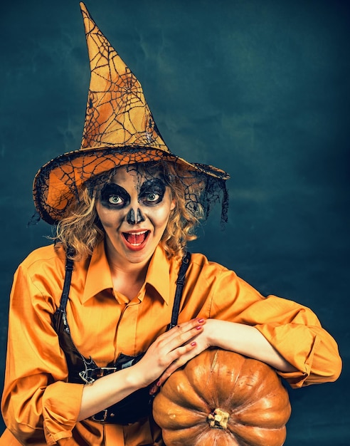 Happy Halloween Wizard Sensual woman in witch Halloween costume with jack o lantern Funny woman dressed like Halloween monster