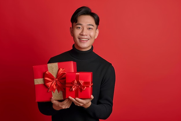 happy handsome asian man holds red and pink gift box valentines day on red