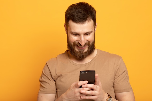 Happy handsome man using a smartphone