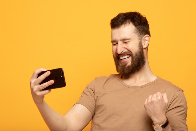 Happy handsome man using a smartphone