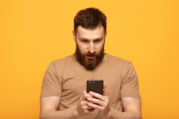 Happy handsome man using a smartphone