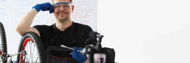 Happy handyman try to fix broken bicycle film process on videocamera