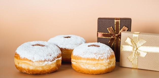 Happy Hanukkah Traditional Jewish dessert Sufganiyot Celebrating Judaism holiday Donuts with jam and sugar powder