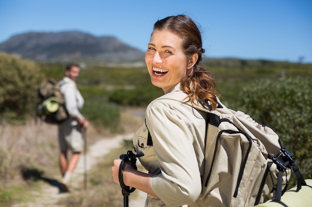 Happy hiking couple walking on country trail