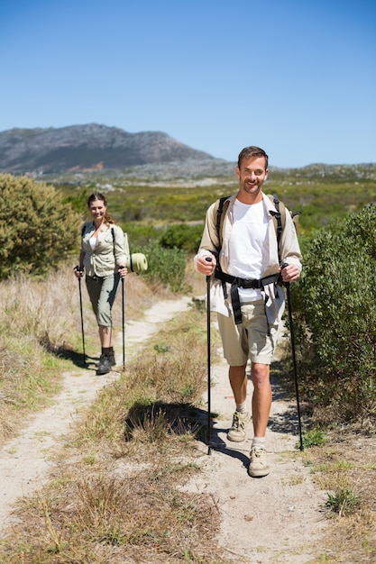 Happy hiking couple walking on country trail