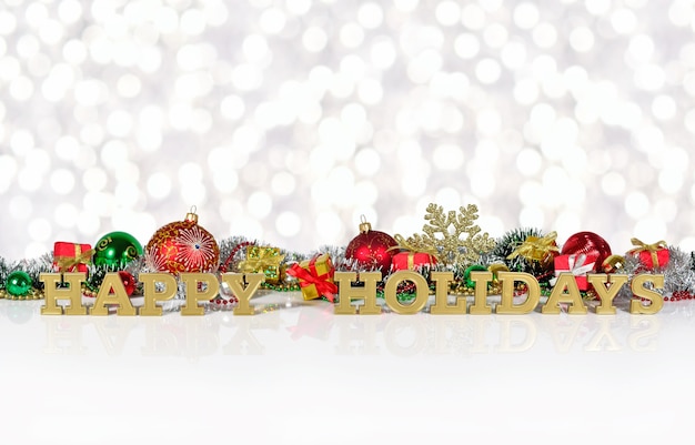 Happy holidays golden text on the background of Christmas decorations