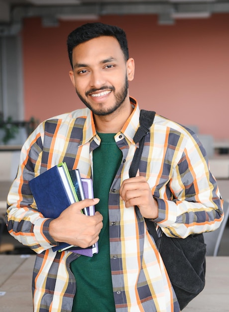 Happy indian male student at the university