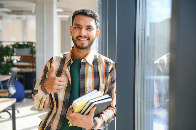 Happy indian male student at the university