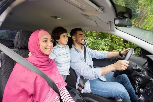 Happy Islamic Family Of Three With Little Son Driving Car Together