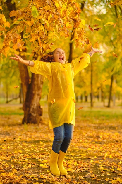 Happy kid in autumn park