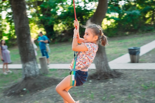 Happy kid enjoying activity in a climbing adventure park.