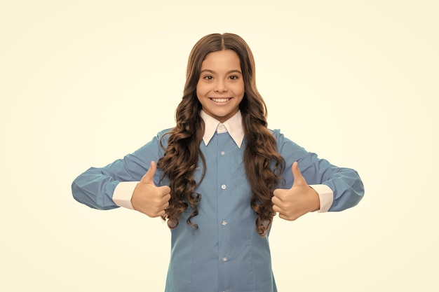 Happy kid portrait has long curly hair isolated on white showing thumb up skin