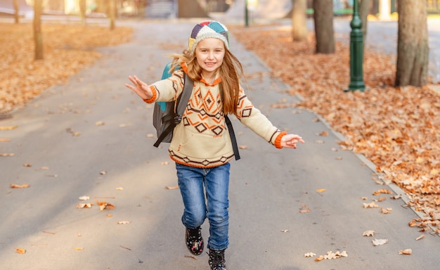 Happy kid running after school