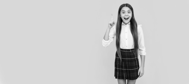 Happy kid in school uniform full length inspired with idea on yellow background idea Child face horizontal poster teenager girl isolated portrait banner with copy space