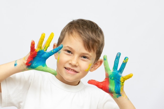 Happy kid with paints on hands