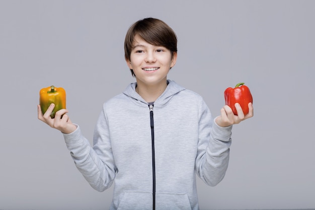 happy kid with sweet pepper healthy eating and lifestyle concept