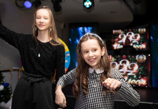 Happy kids dancing at a holiday party in the club celebrating a birthday