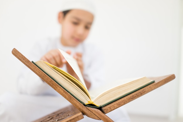 Happy kids reading Koran