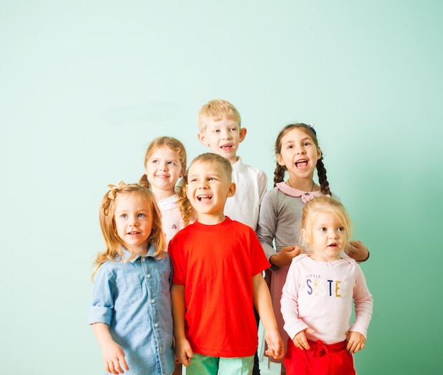 Happy kids singing song together at kindergarden at music lesson