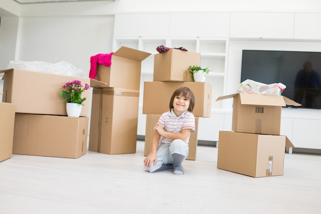 Happy kids with boxes at new modern home